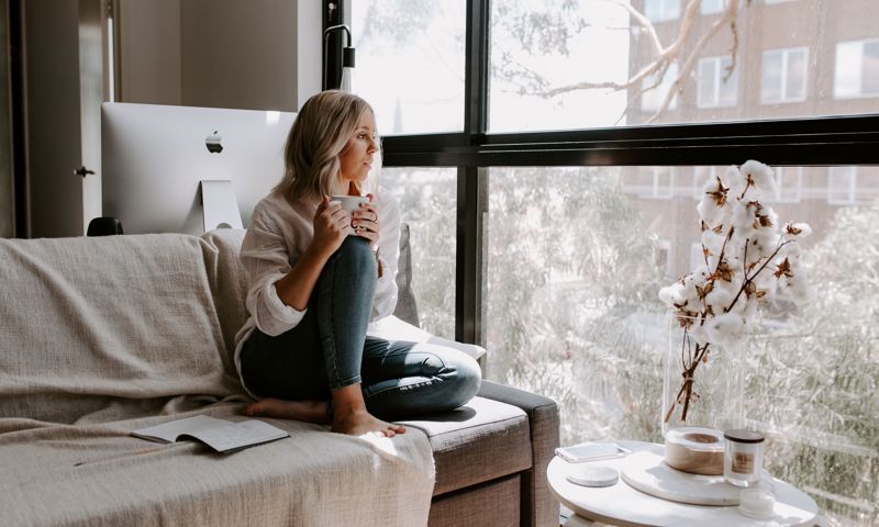 Woman at home looking out the window