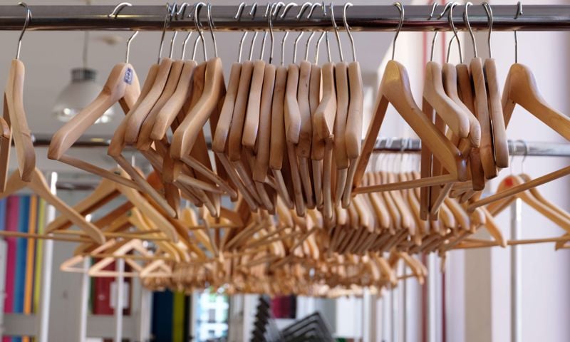 Wooden hangers on a clothes rack