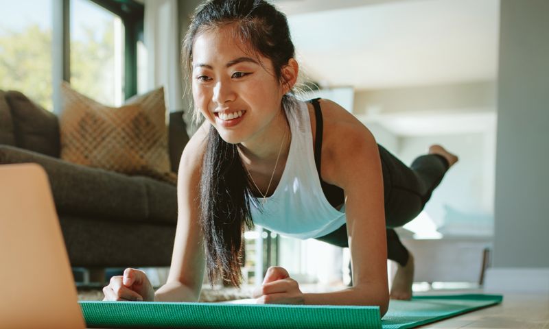A woman exercising in front of the computer
