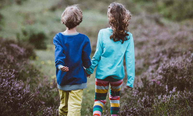 Two kids walking in the hills