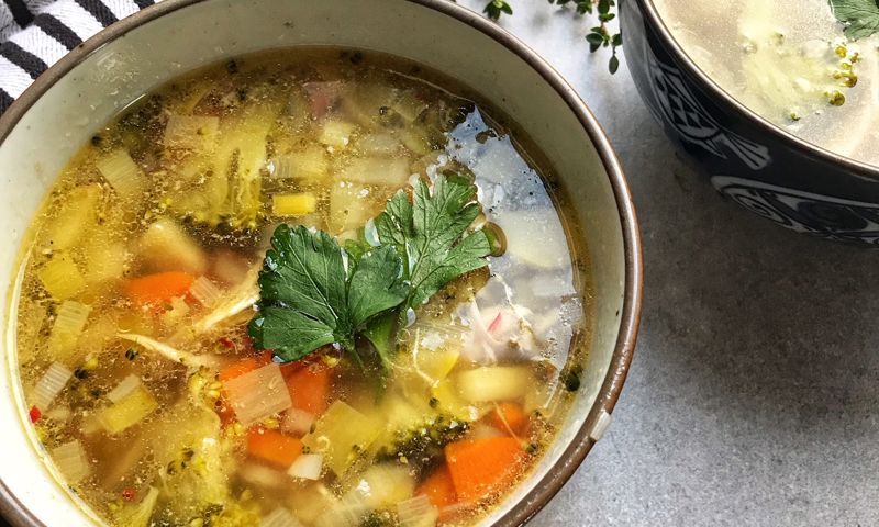 Bowl of soup with herbs