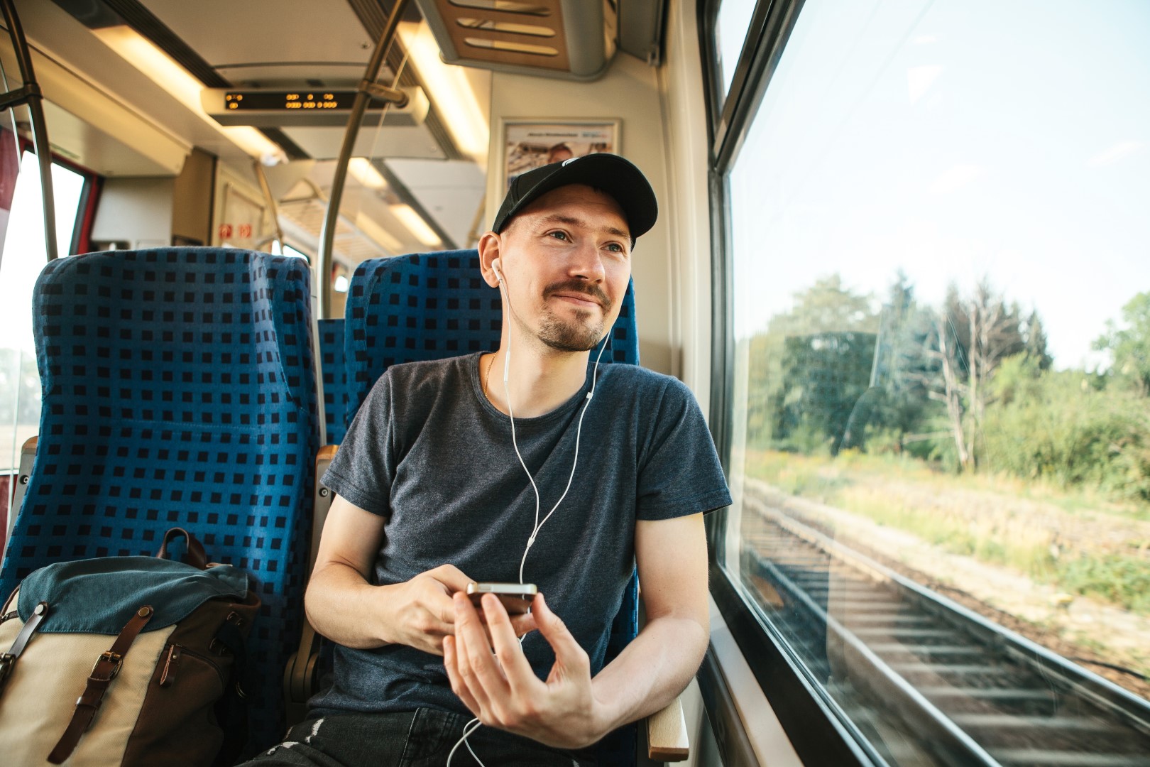 Man listens to GMHBA podcast on train