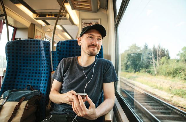 Man listens to GMHBA podcast on train