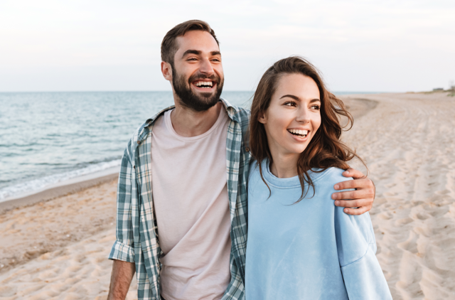 Couple walking together on the beach after saving at tax time with their health insurance hospital cover