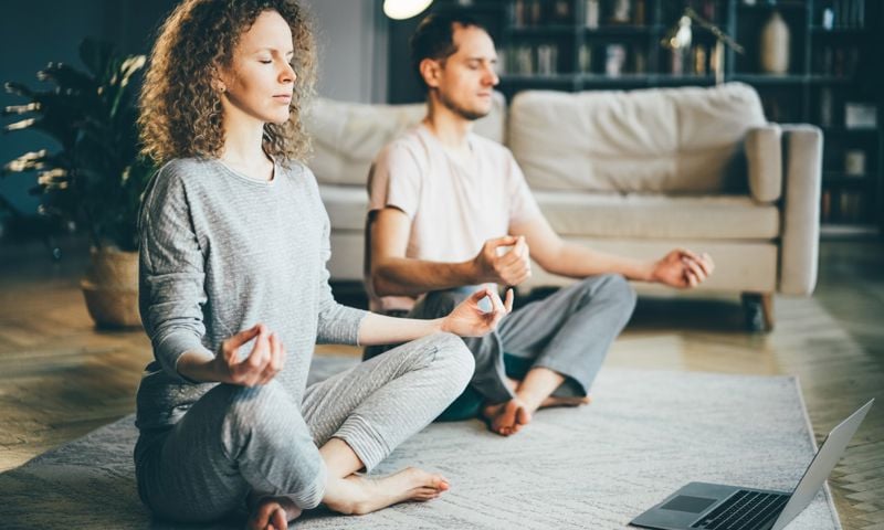 Two people meditating after reading a healthier together article