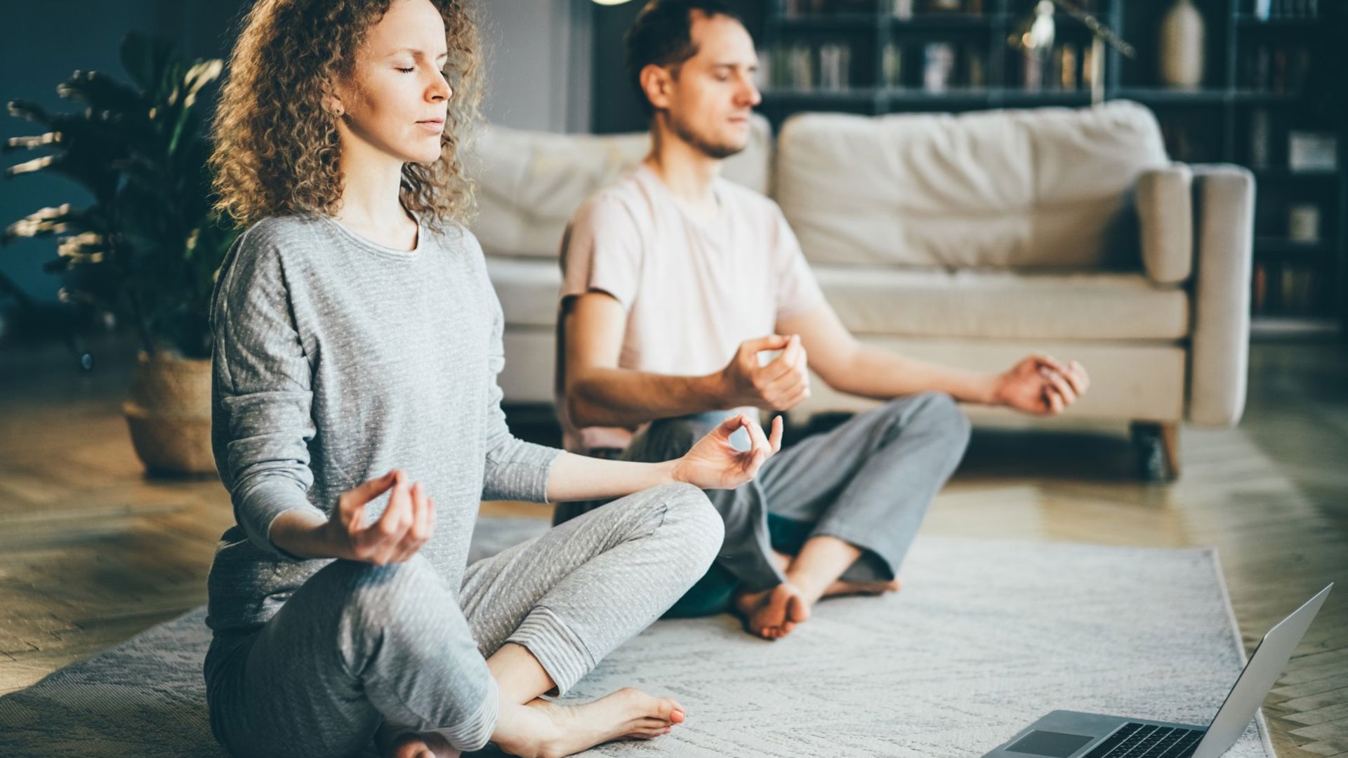 Two people meditating after reading a healthier together article