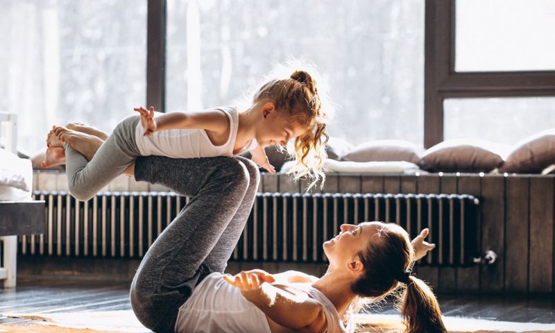 Mother and daughter yoga at home after learning skill at GMHBA seminar