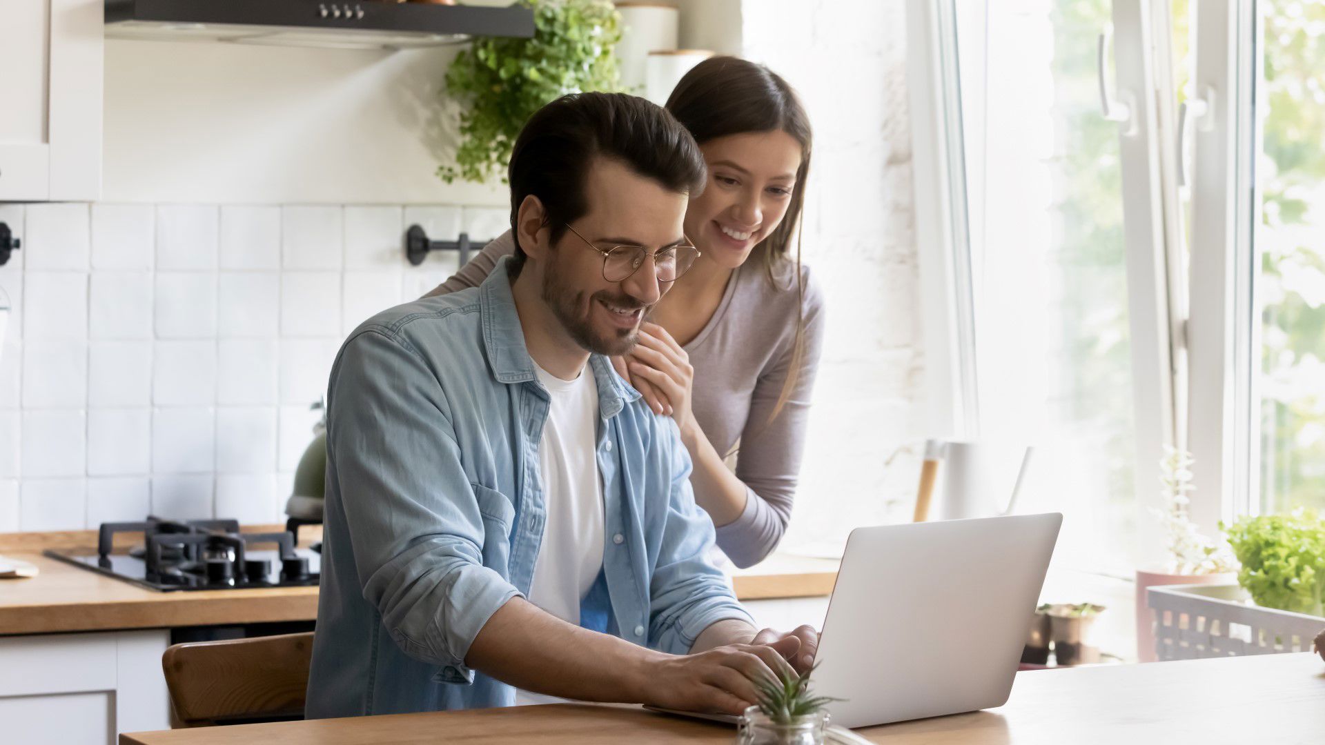 Couple spending time together in the kitchen whilst joining combined cover with GMHBA