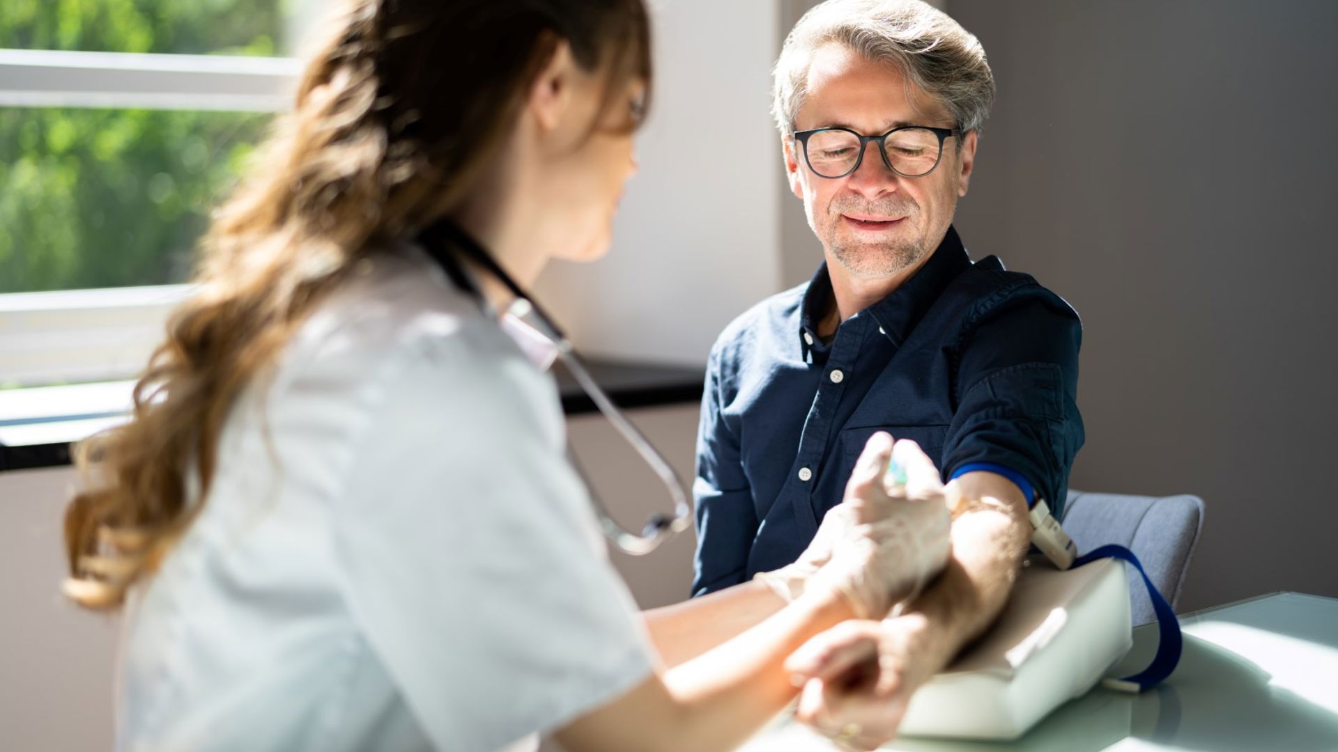 Man getting blood draw at a GMHBA medical clinic