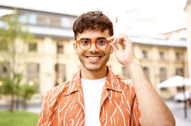 Young Man with glasses happy because he has optical extras and gets great Eye Care Benfits with GMHBA