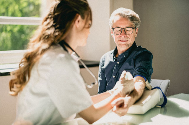 Man getting a needle from the doctor