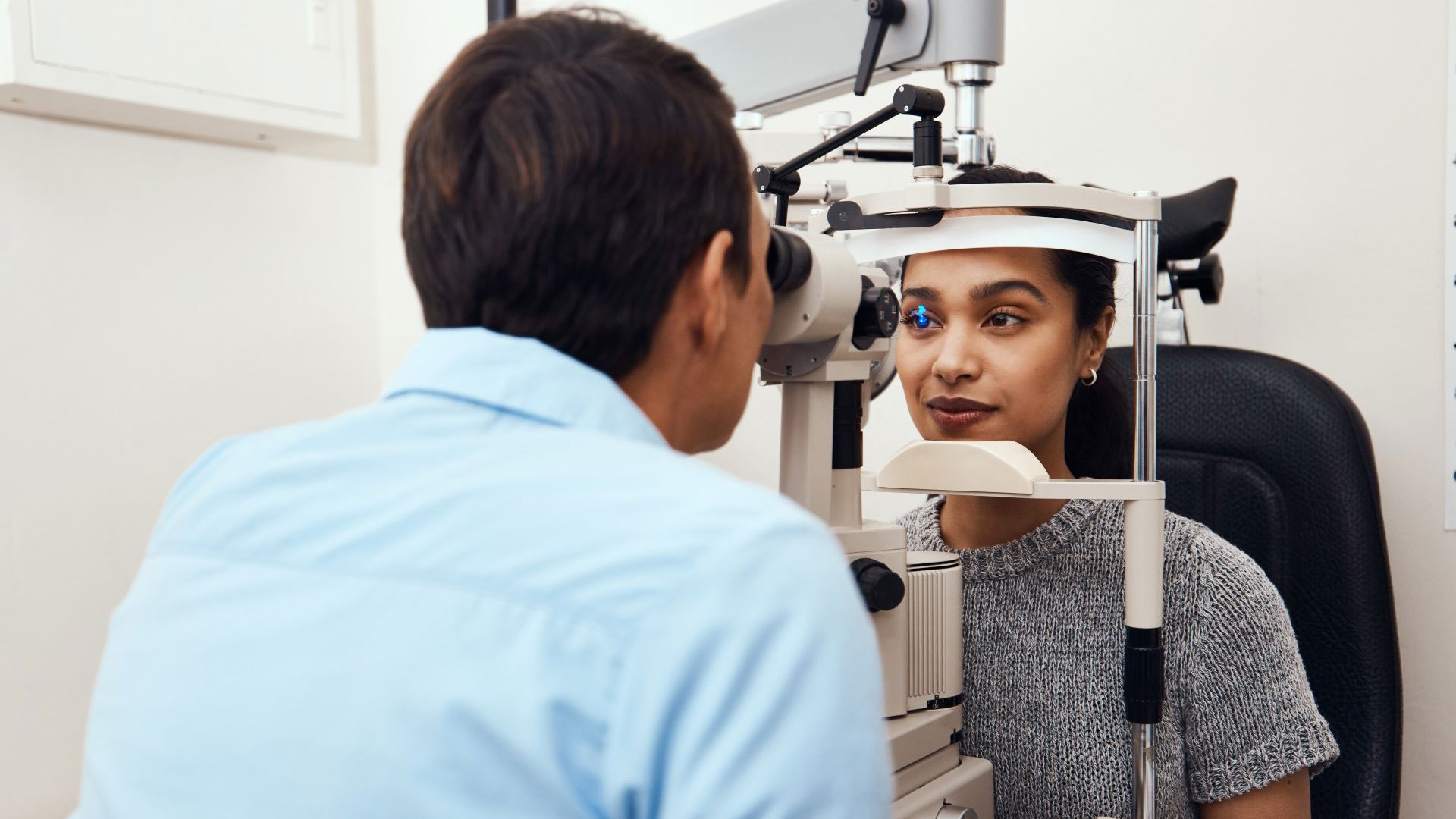 woman getting eye test with optometrist GMHBA EyeCare 
