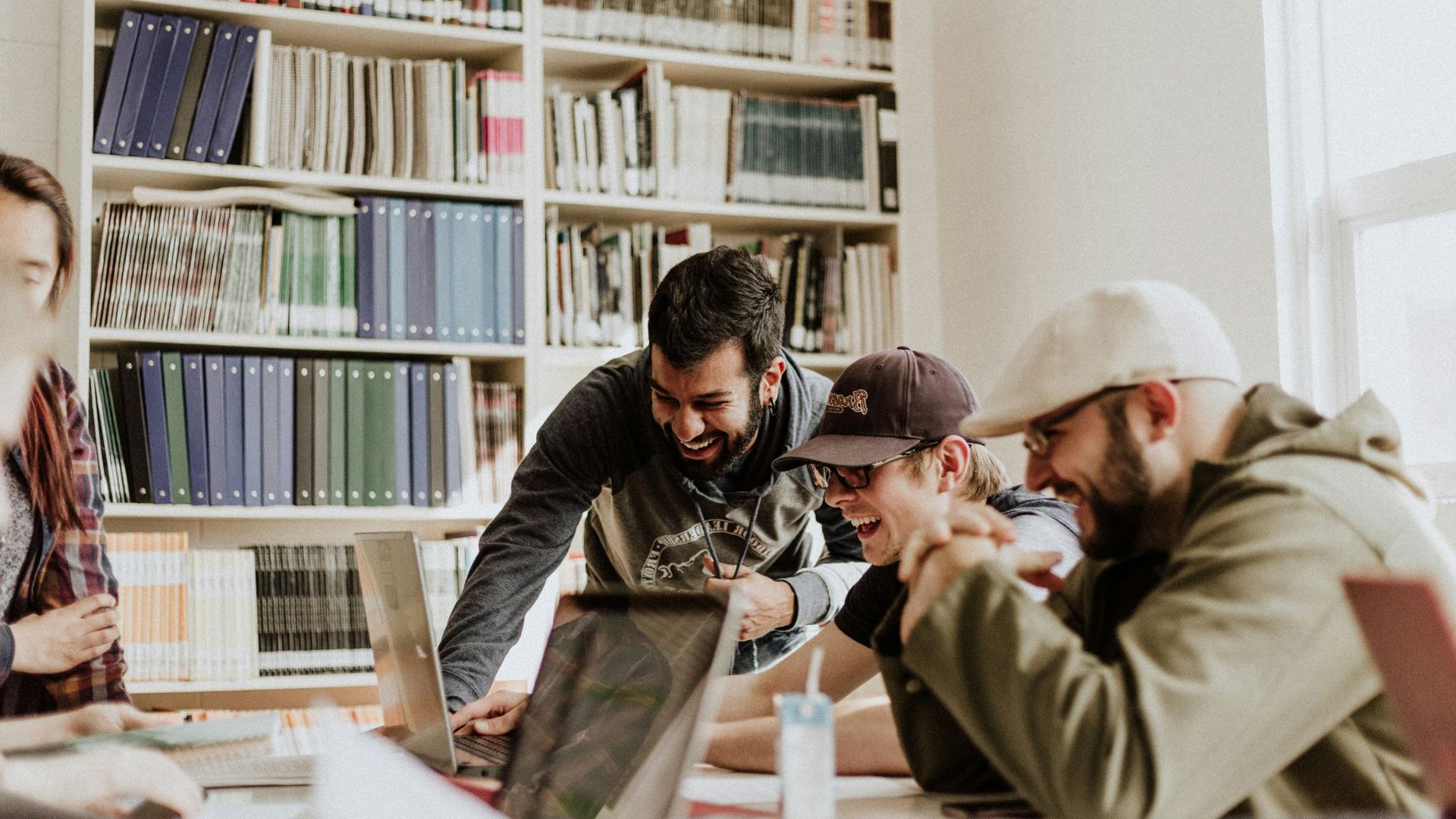 young guys looking at health insurance laughing