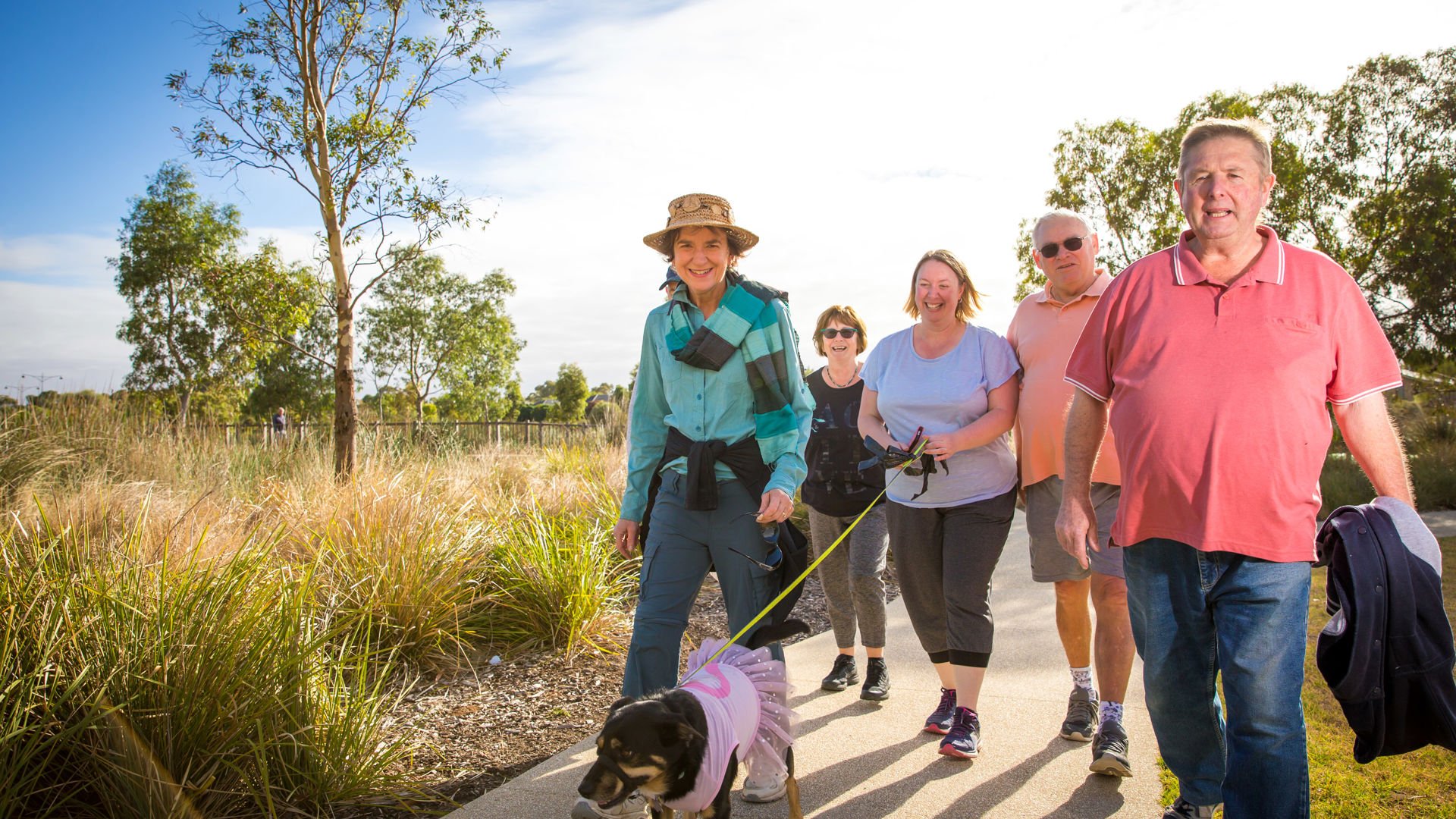 A variety of people walking together outside