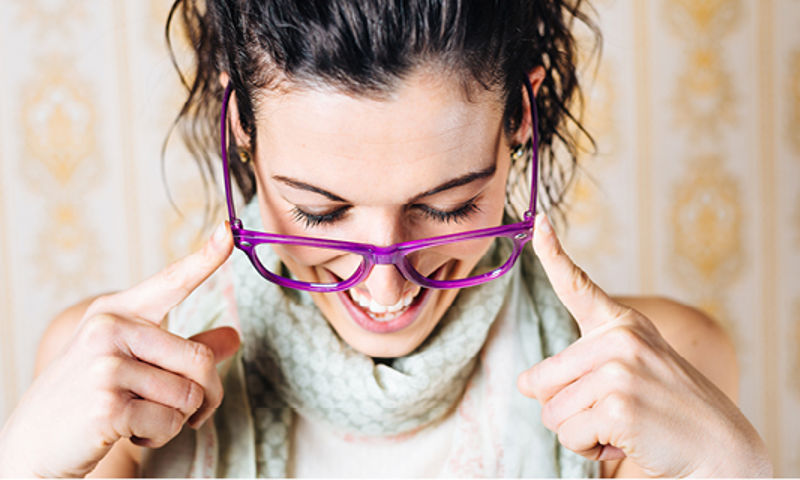 Woman wearing glasses and looking down
