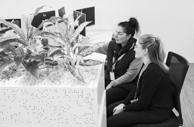 Office worker showing graduate how a process works