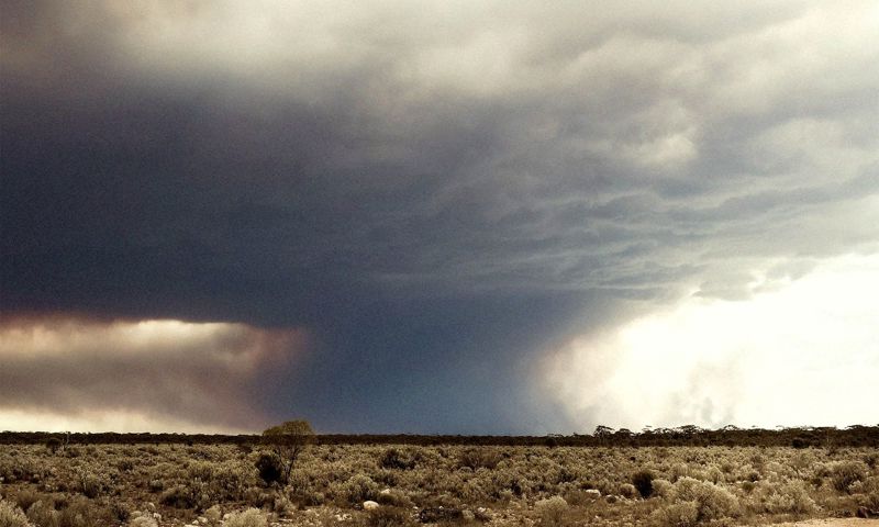 A plume of smoke hovers threatening all around as the unpredicting flames make their own way through the dry Western Australian outback.