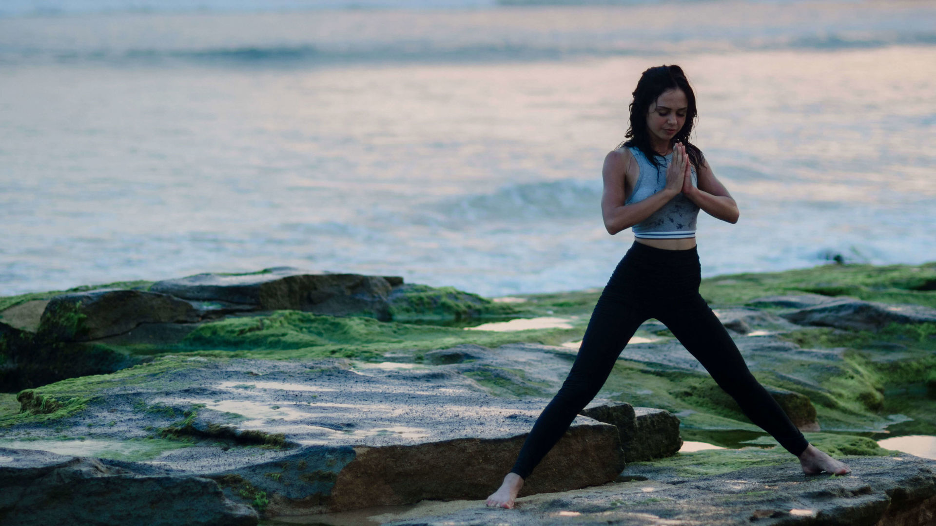Lady doing yoga on beach