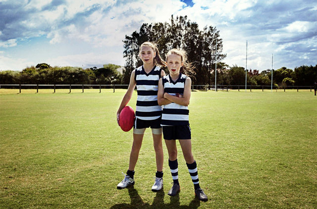 Young girls having a break during a game of AFL football