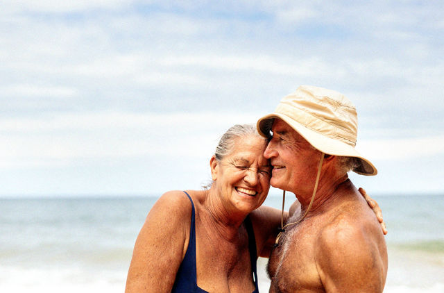 Couple enjoying a day at the beach knowing they won't have to reserve hospital waiting periods