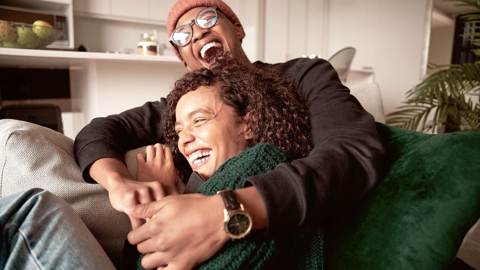 Couple cuddling on the couch talking about their health journeys