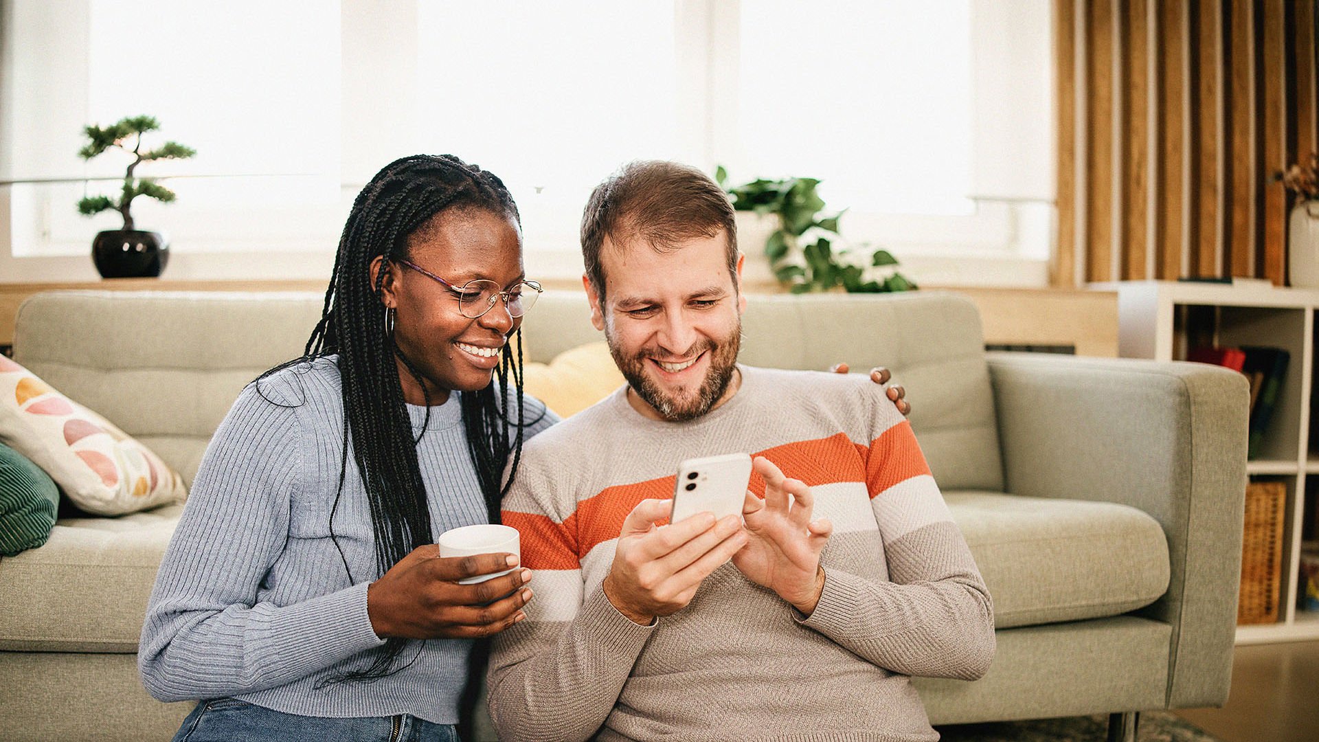 Happy GMHBA Couple looking at their SmartCare Boost Extras coverage and the inclusions of Optical and Annual Limit Rollover.