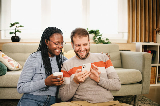Happy GMHBA Couple looking at their SmartCare Boost Extras coverage and the inclusions of Optical and Annual Limit Rollover.