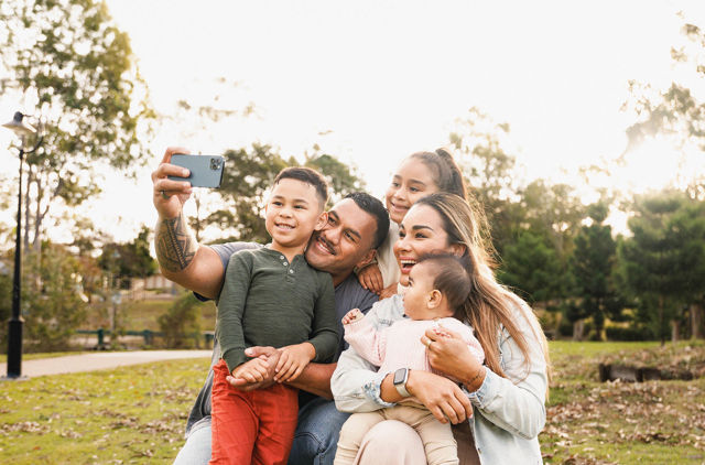 happy family enjoying time together and taking selfie