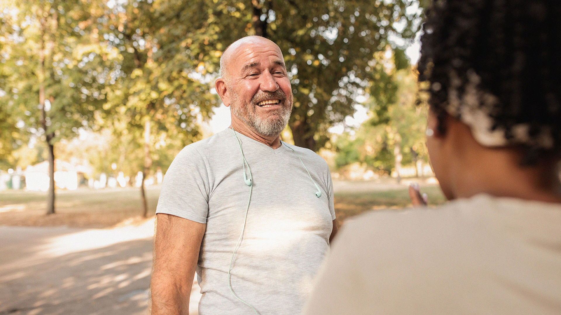 Middle aged male GMHBA extras member exercising in the park with friends laughing on a sunny day