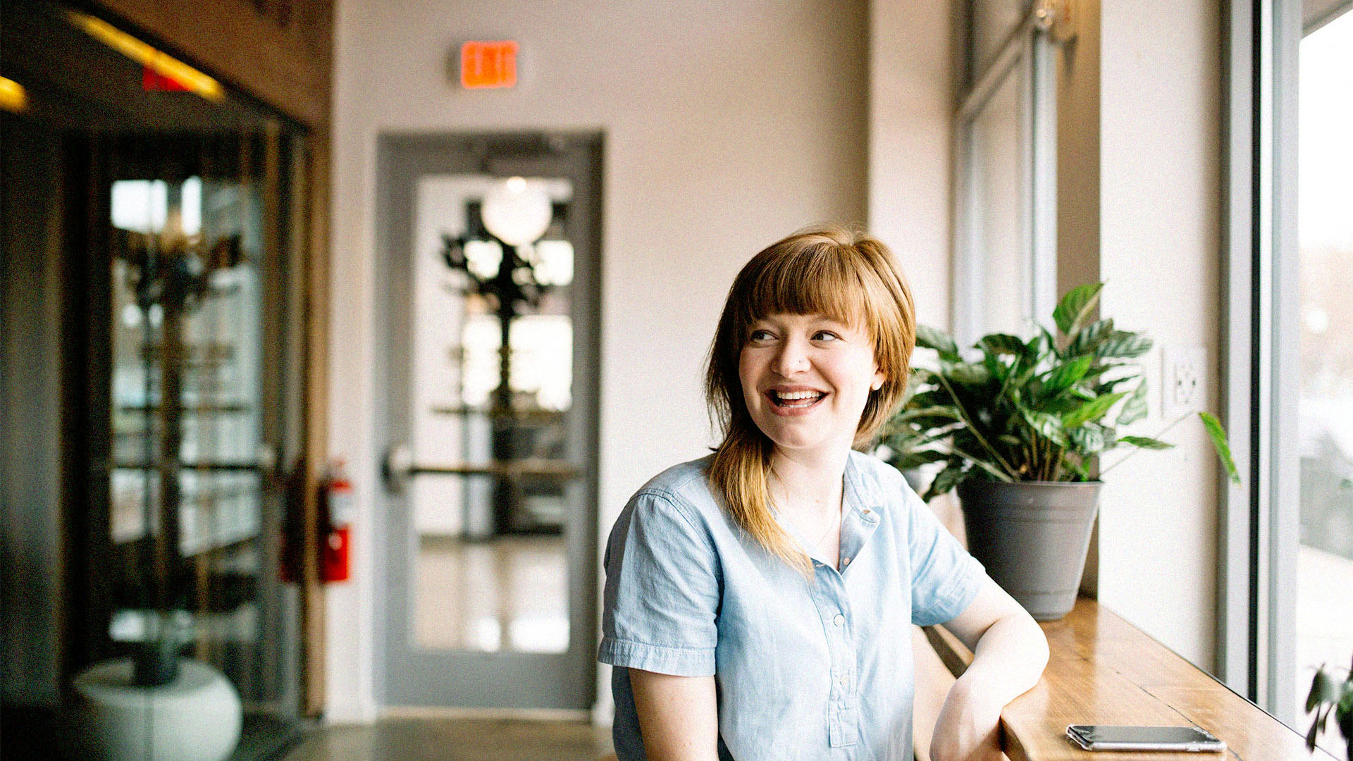 All Abilities woman sitting in cafe looking out the window