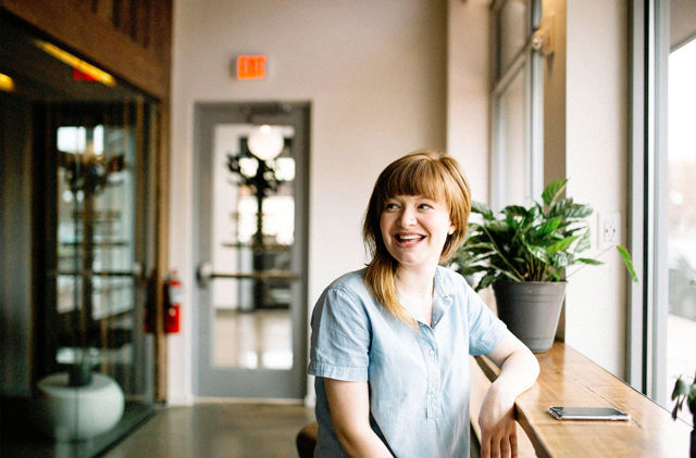 All Abilities woman sitting in cafe looking out the window