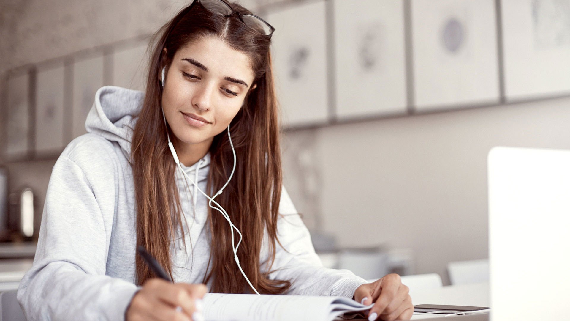 Mid 20s girl working from a cafe considering the age based discount on GMHBA health insurance