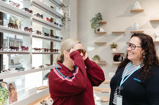 Lady trying on sunglasses at GMHBA's Geelong Hub