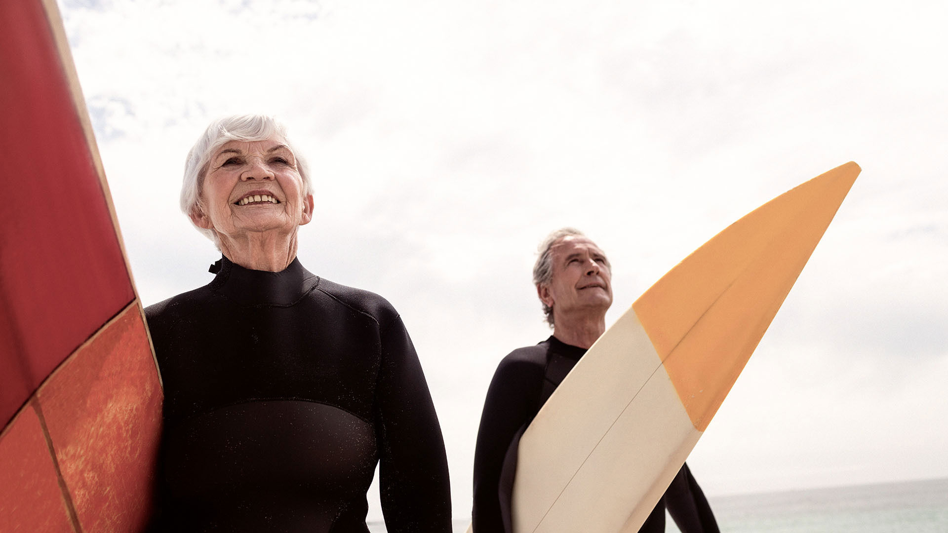 Older couple surfing and being active