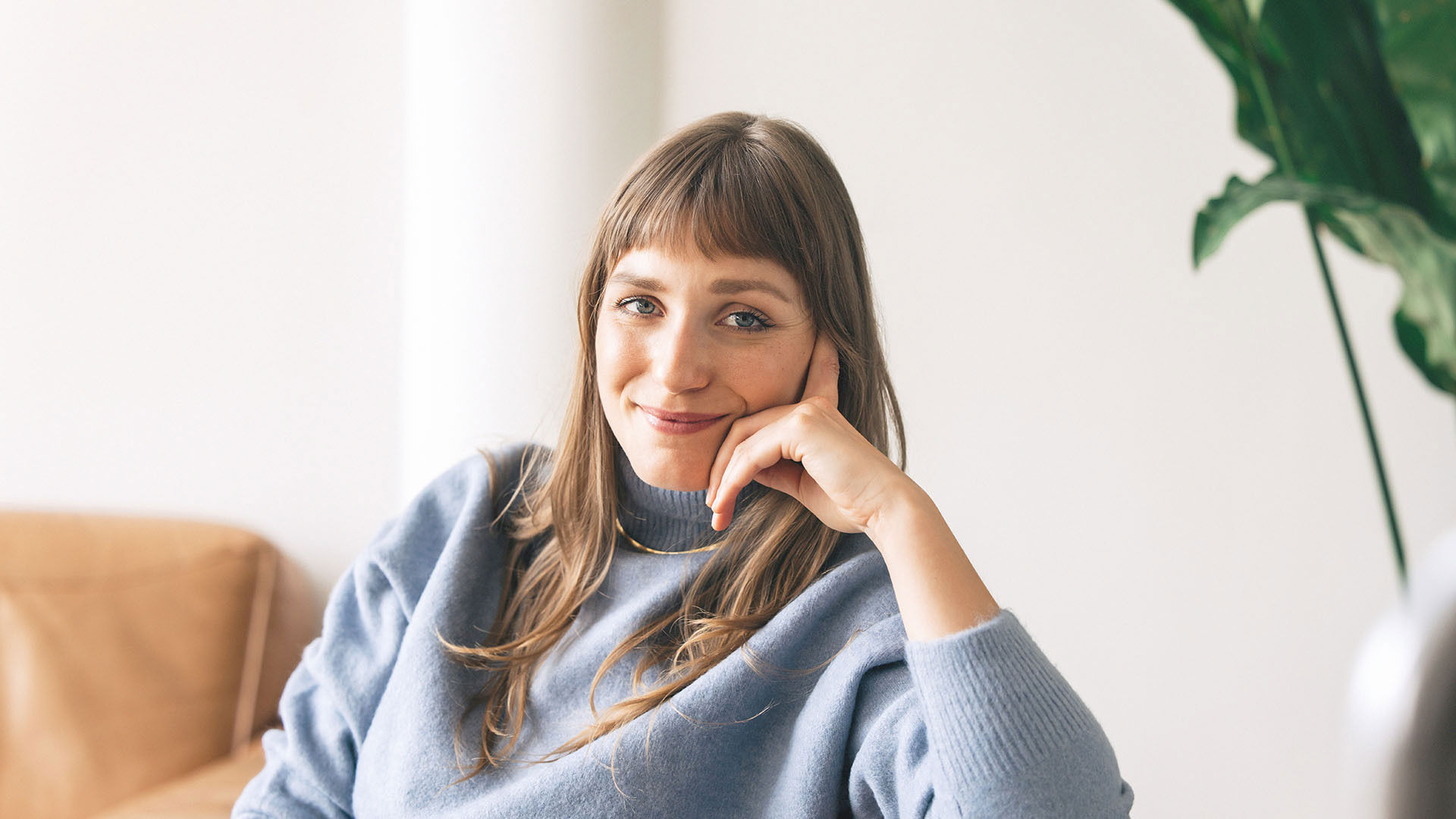 Woman sitting on the couch contemplating