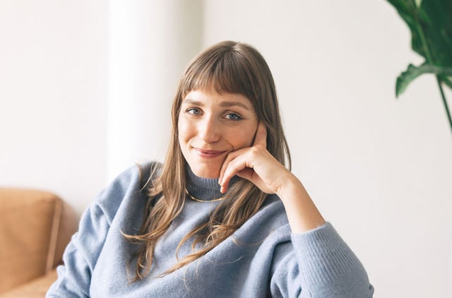Woman sitting on the couch contemplating