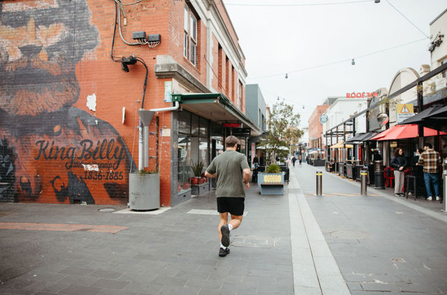 Man jogging down Little Malop Street