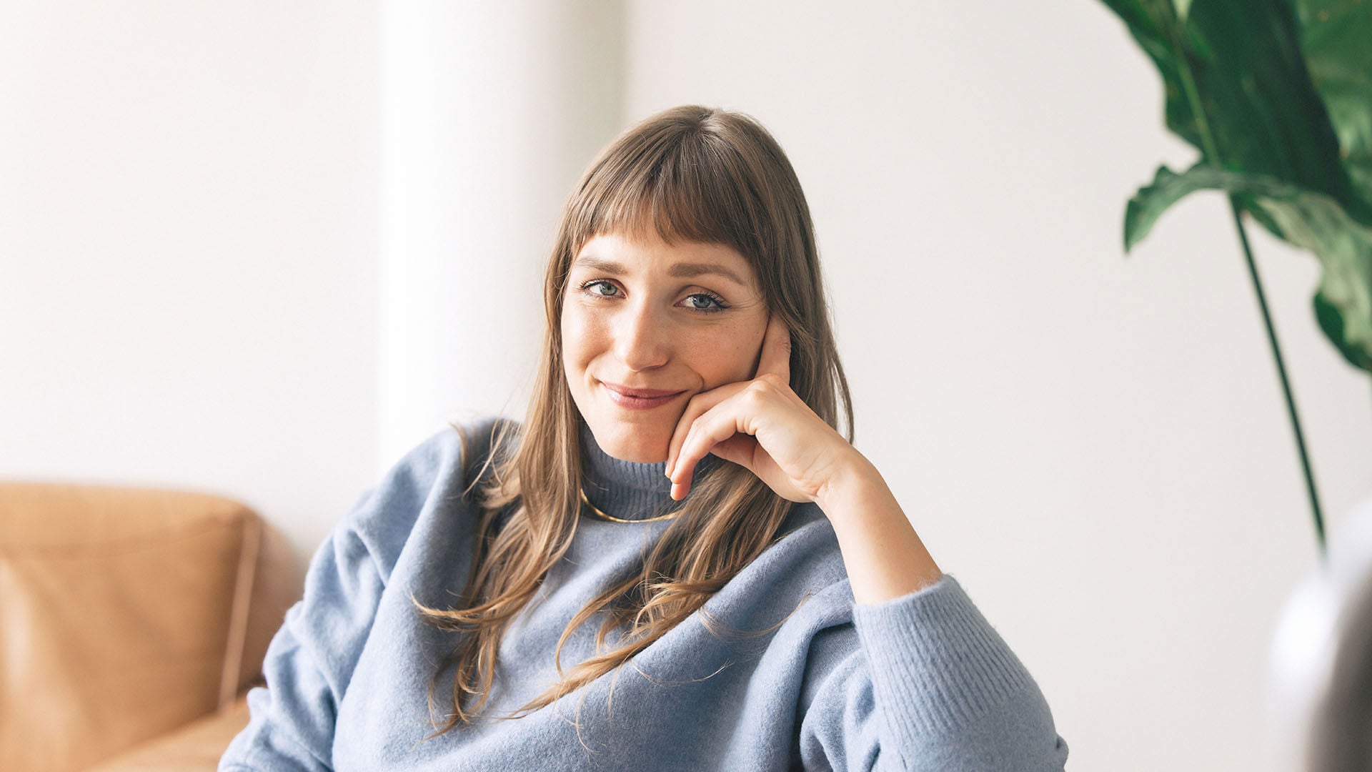 Woman sitting on the couch contemplating